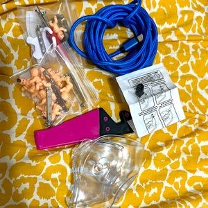 Pink and Black Handheld Tool with Accessories